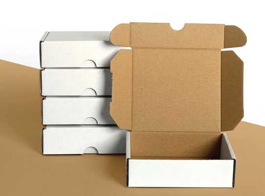 Open corrugated shipping boxes stacked for packing